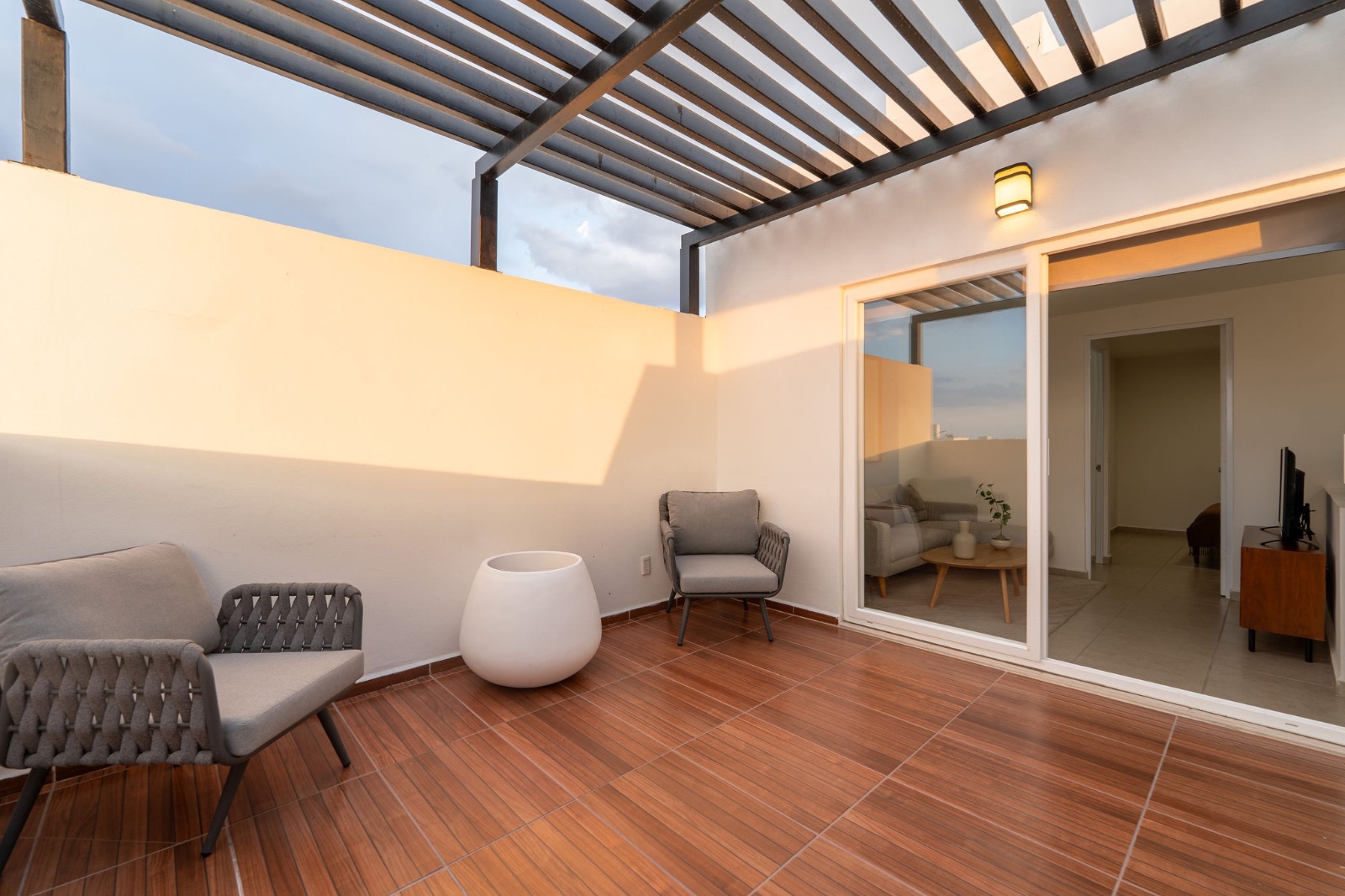 Terraza con pérgola y sala exterior