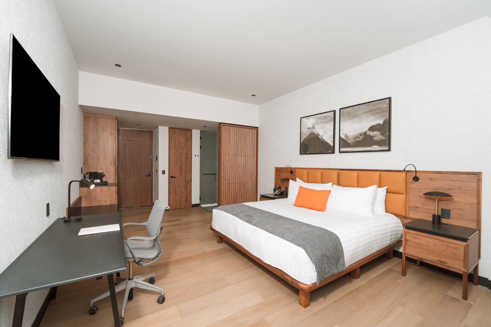 Suite tipo hotel con cama, televisión y escritorio
